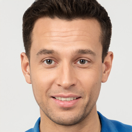 Joyful white young-adult male with short  brown hair and brown eyes