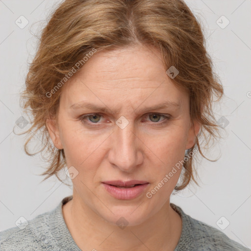 Joyful white adult female with medium  brown hair and blue eyes