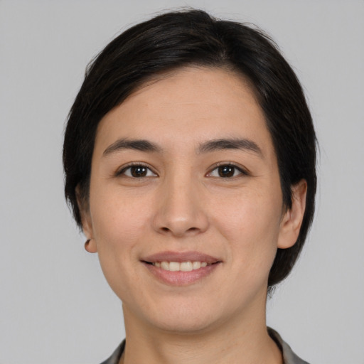 Joyful white young-adult female with short  black hair and brown eyes
