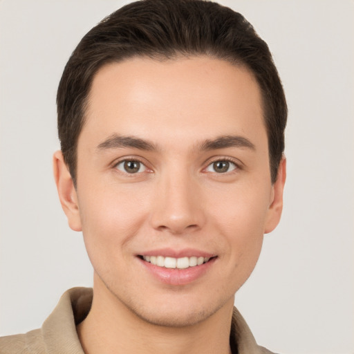 Joyful white young-adult male with short  brown hair and brown eyes