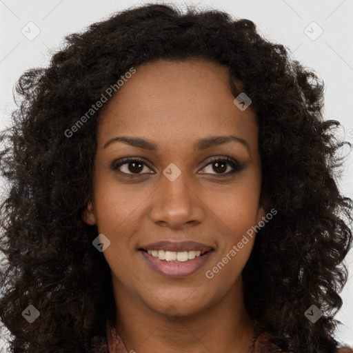 Joyful black young-adult female with long  brown hair and brown eyes