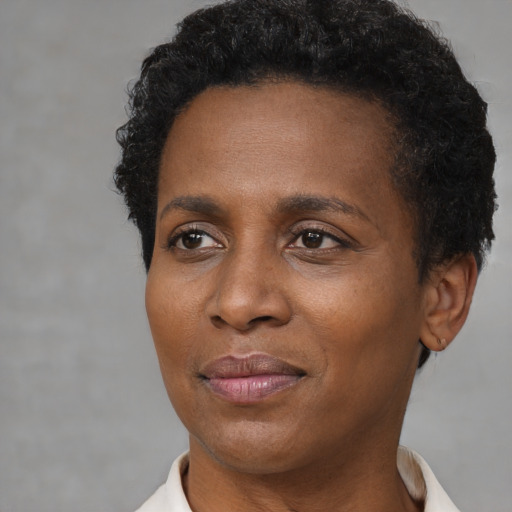 Joyful black adult female with short  brown hair and brown eyes