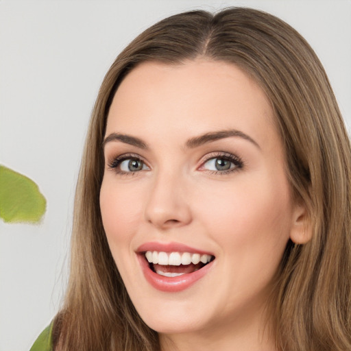 Joyful white young-adult female with long  brown hair and green eyes