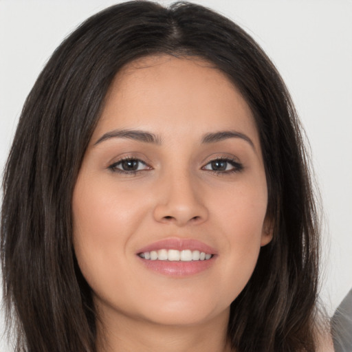 Joyful white young-adult female with long  brown hair and brown eyes