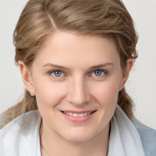 Joyful white young-adult female with medium  brown hair and blue eyes