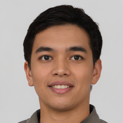 Joyful asian young-adult male with short  black hair and brown eyes