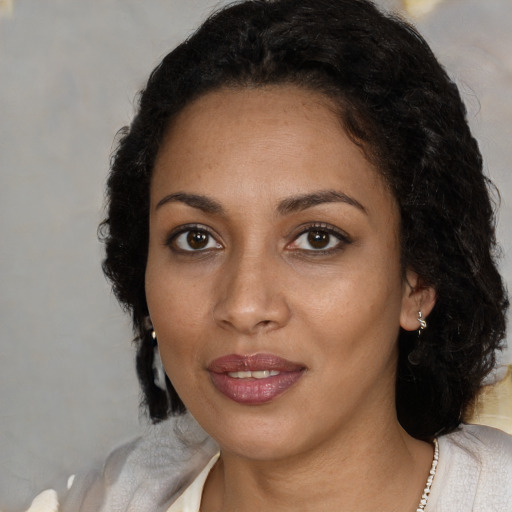 Joyful black adult female with medium  black hair and brown eyes