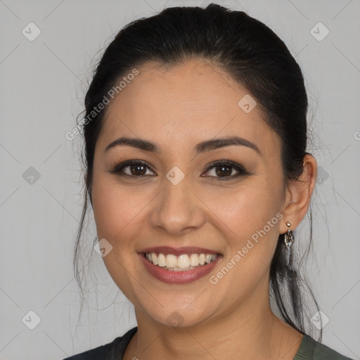 Joyful latino young-adult female with medium  brown hair and brown eyes