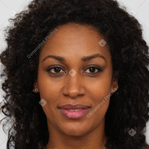 Joyful black young-adult female with long  brown hair and brown eyes