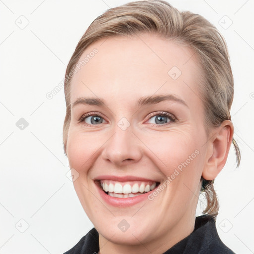 Joyful white young-adult female with medium  brown hair and blue eyes