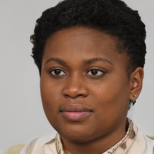 Joyful black young-adult female with short  brown hair and brown eyes