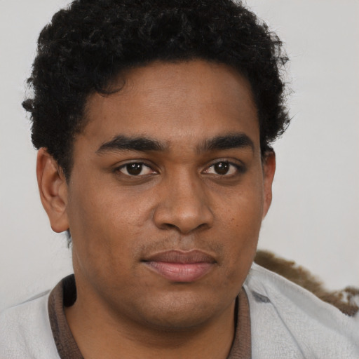 Joyful latino young-adult male with short  brown hair and brown eyes