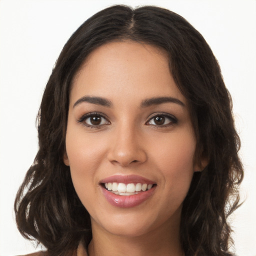 Joyful white young-adult female with long  brown hair and brown eyes