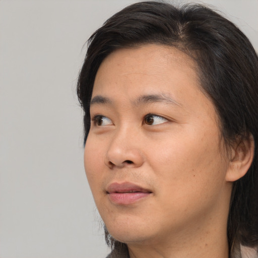 Joyful asian young-adult male with medium  brown hair and brown eyes
