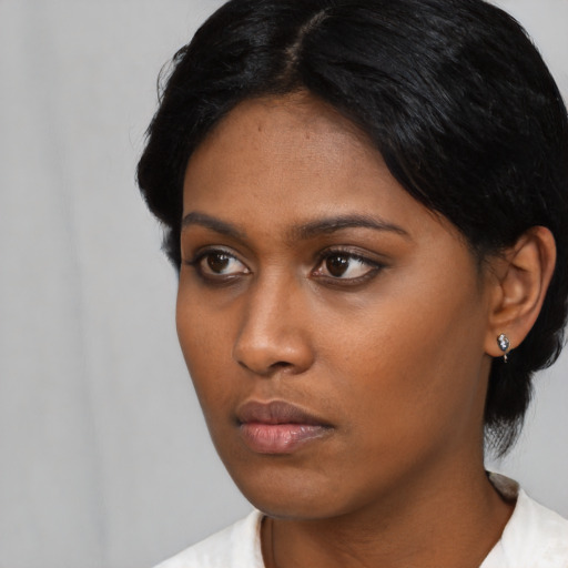 Neutral black young-adult female with short  black hair and brown eyes