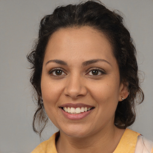 Joyful latino young-adult female with medium  brown hair and brown eyes