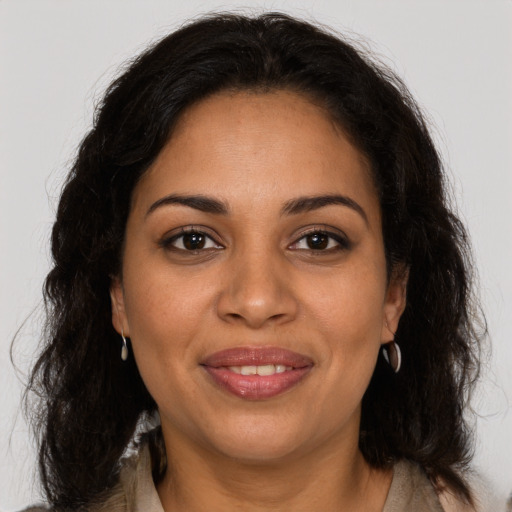 Joyful latino young-adult female with long  brown hair and brown eyes