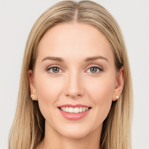 Joyful white young-adult female with long  brown hair and green eyes