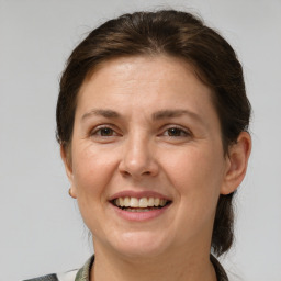 Joyful white adult female with medium  brown hair and brown eyes