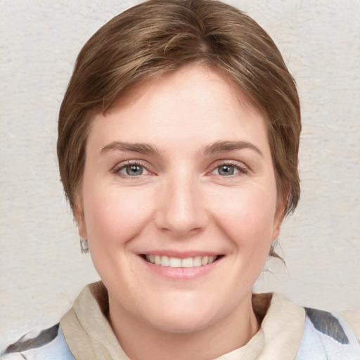 Joyful white young-adult female with medium  brown hair and blue eyes