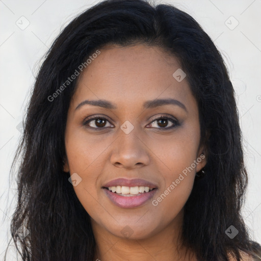 Joyful black young-adult female with long  brown hair and brown eyes