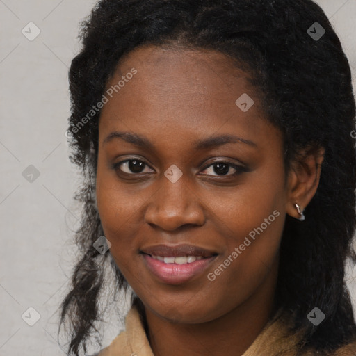 Joyful black young-adult female with long  black hair and brown eyes