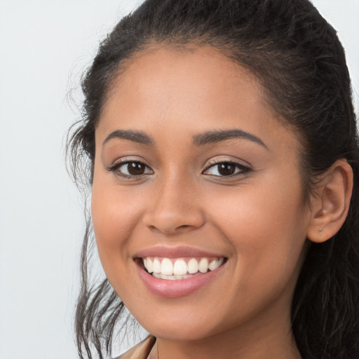 Joyful white young-adult female with long  brown hair and brown eyes