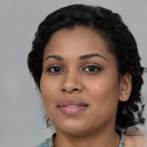Joyful black young-adult female with medium  black hair and brown eyes