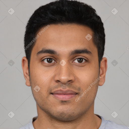 Joyful latino young-adult male with short  black hair and brown eyes