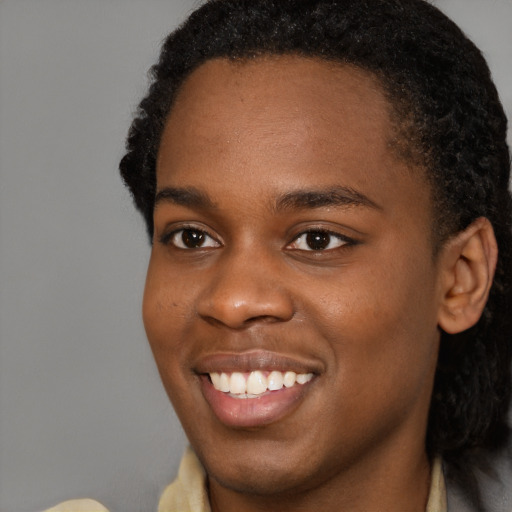 Joyful black young-adult female with short  brown hair and brown eyes