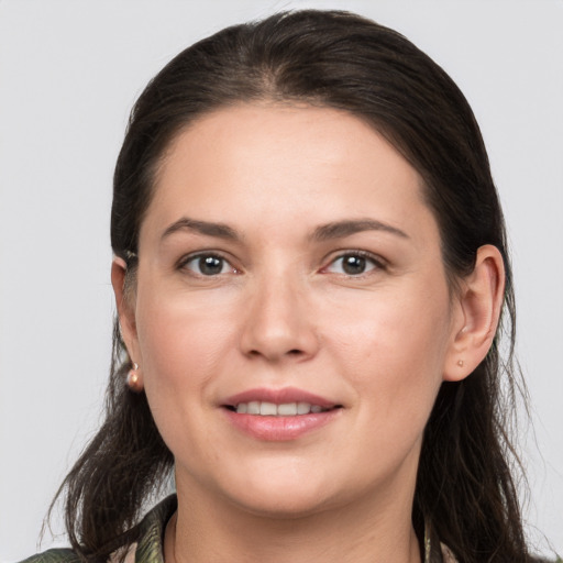 Joyful white young-adult female with long  brown hair and grey eyes