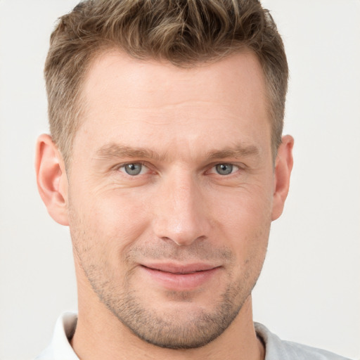 Joyful white adult male with short  brown hair and grey eyes