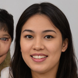 Joyful asian young-adult female with long  brown hair and brown eyes