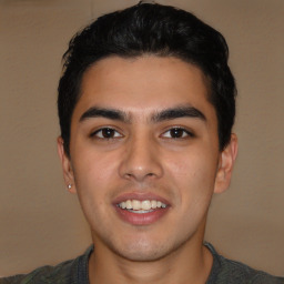 Joyful latino young-adult male with short  brown hair and brown eyes