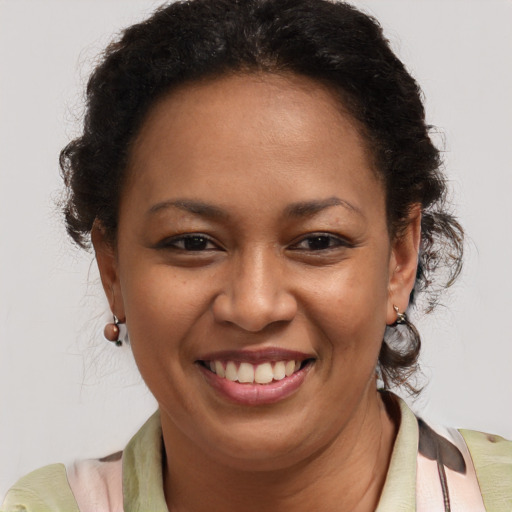 Joyful latino adult female with short  brown hair and brown eyes