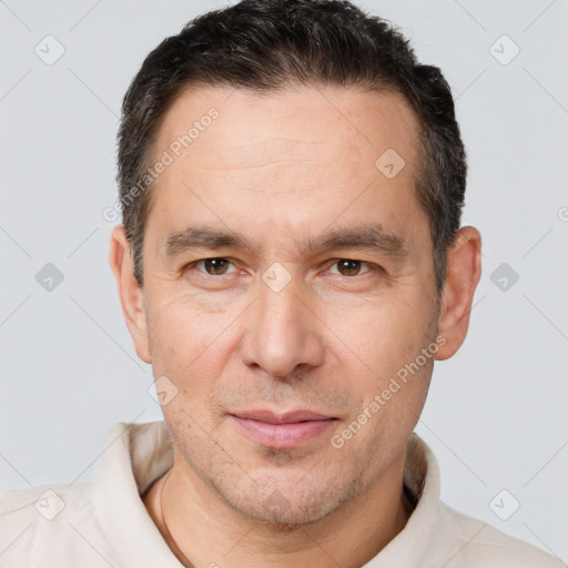 Joyful white adult male with short  brown hair and brown eyes