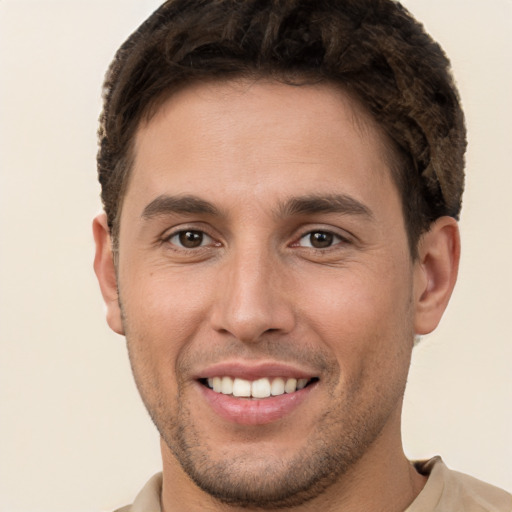 Joyful white young-adult male with short  brown hair and brown eyes