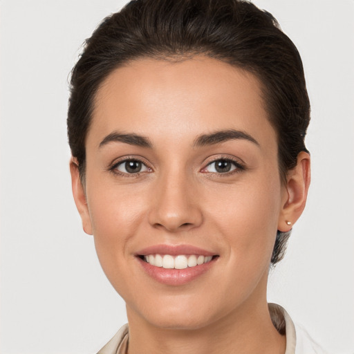 Joyful white young-adult female with short  brown hair and brown eyes