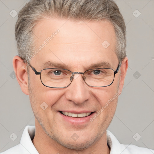 Joyful white adult male with short  brown hair and grey eyes