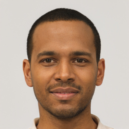 Joyful black young-adult male with short  black hair and brown eyes