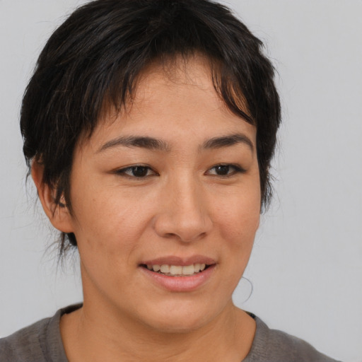 Joyful asian young-adult female with medium  brown hair and brown eyes
