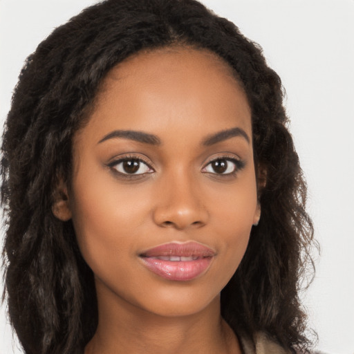 Joyful black young-adult female with long  brown hair and brown eyes