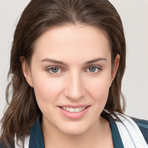 Joyful white young-adult female with medium  brown hair and grey eyes