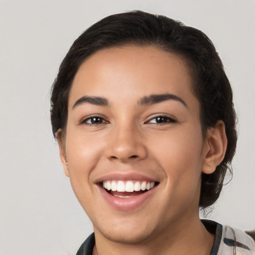 Joyful white young-adult female with short  black hair and brown eyes