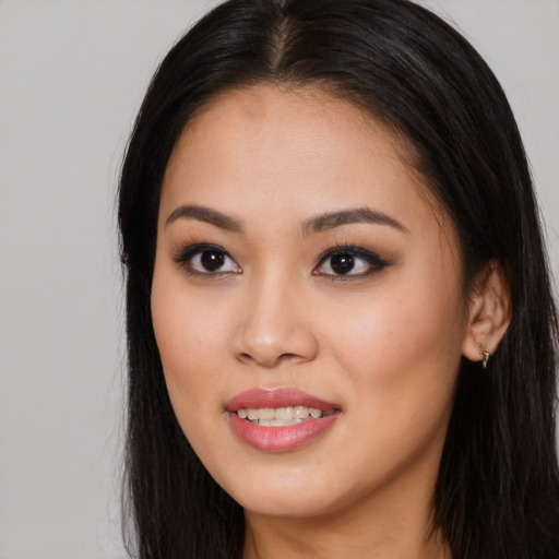 Joyful asian young-adult female with long  brown hair and brown eyes