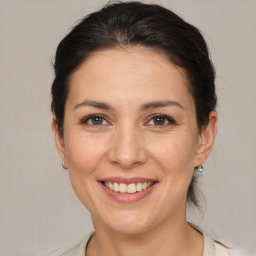 Joyful white adult female with medium  brown hair and brown eyes