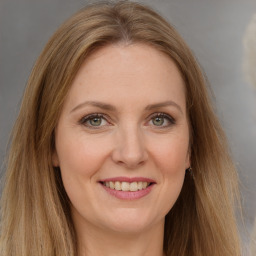 Joyful white young-adult female with long  brown hair and green eyes