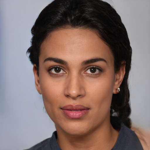 Joyful latino young-adult female with medium  black hair and brown eyes