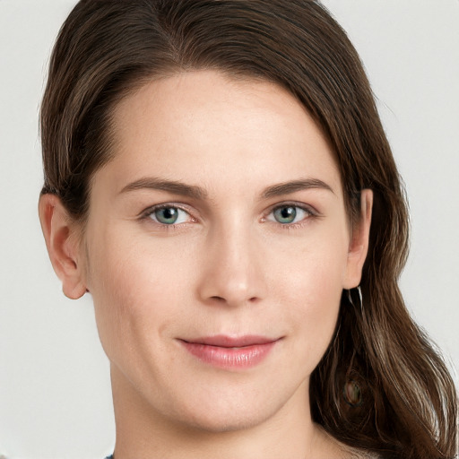 Joyful white young-adult female with long  brown hair and grey eyes