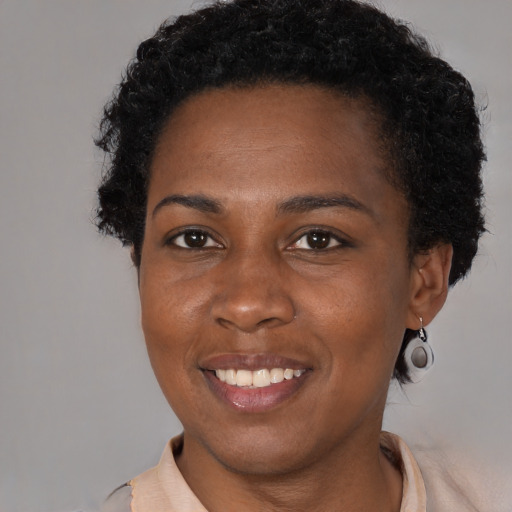 Joyful black young-adult female with short  brown hair and brown eyes